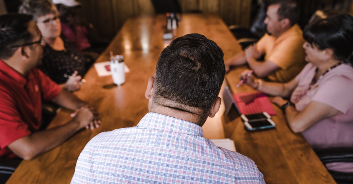 Supervisors talking around a table